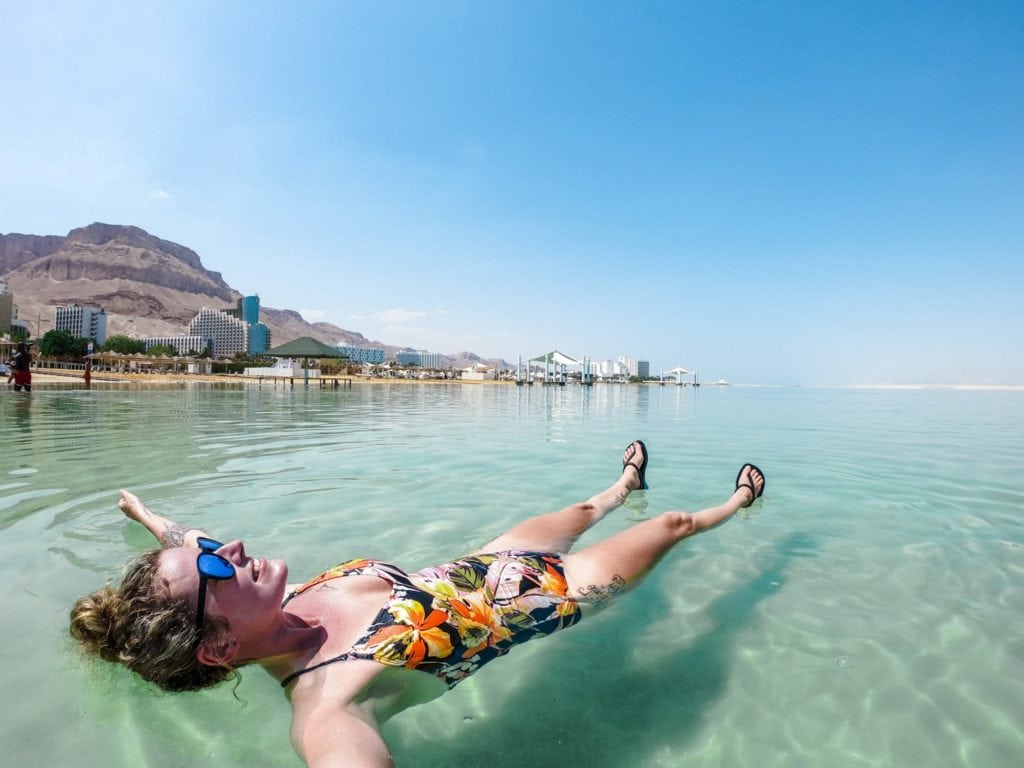 people floating in the dead sea