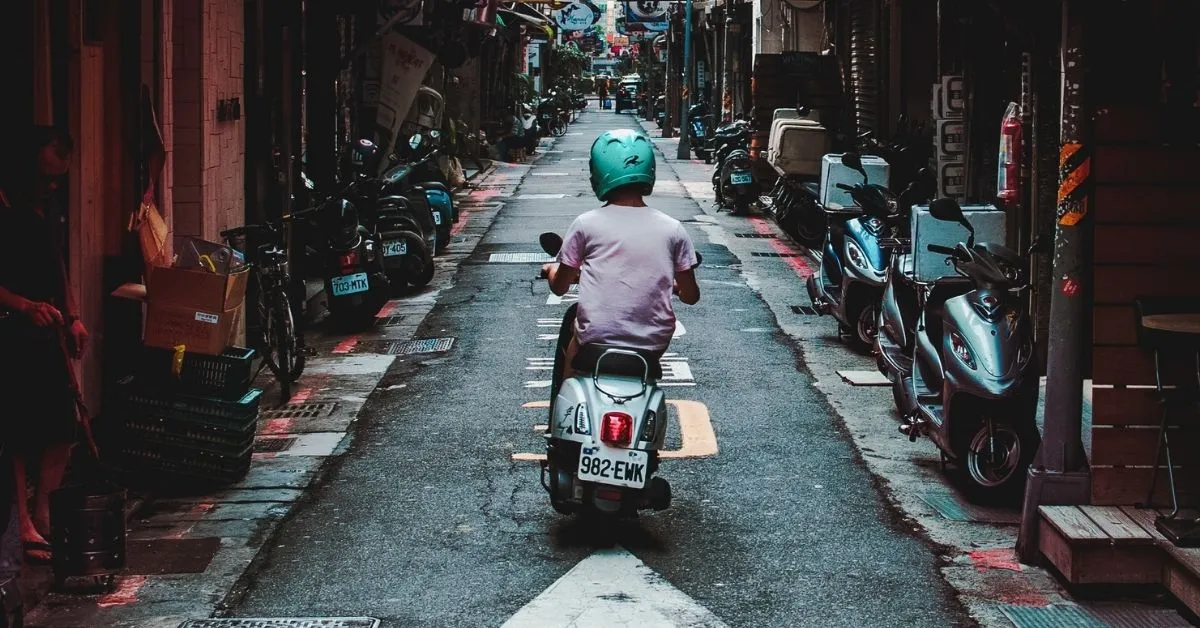 man driving a scooter in thailand