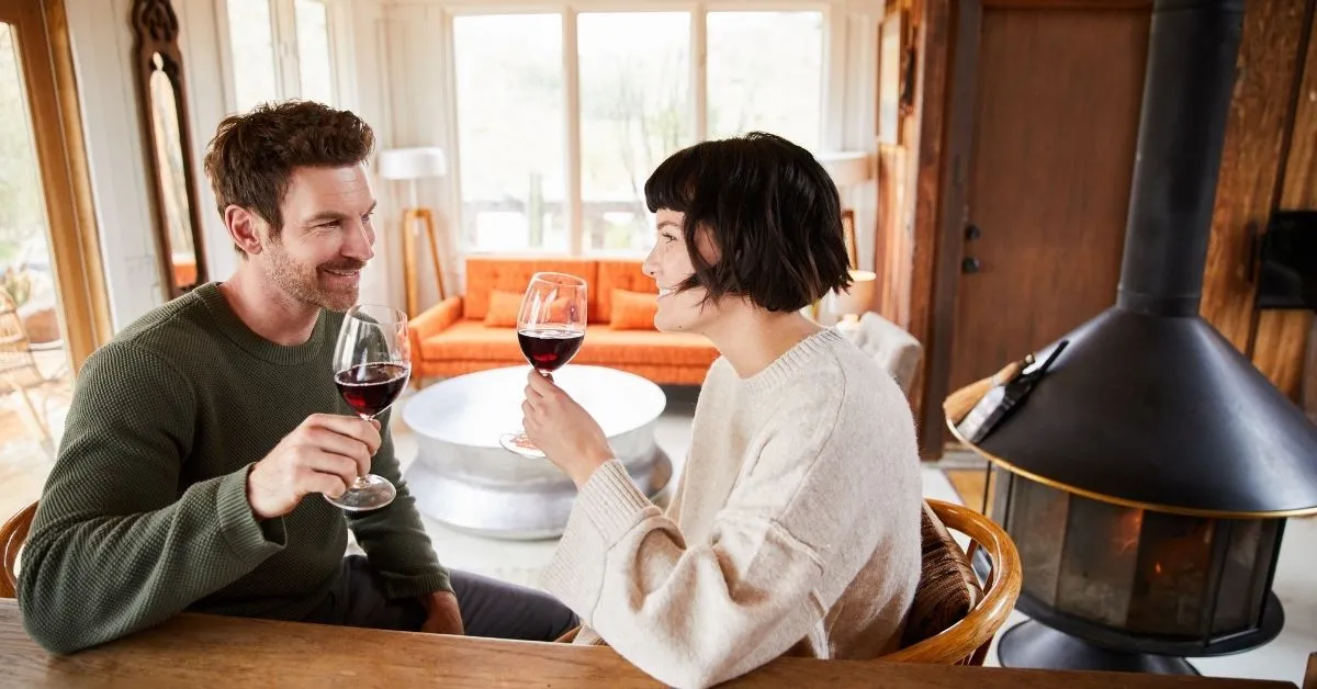 Couple drinking wine in a cabin