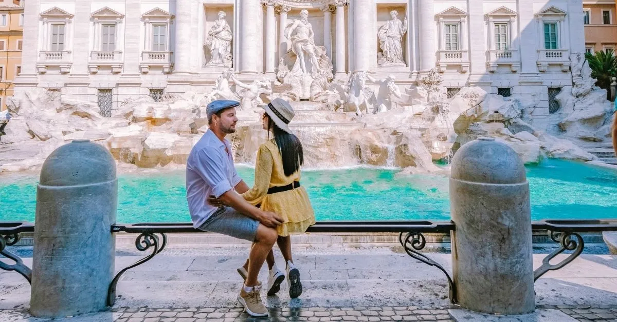 Couple getting engaged in front of the trevi fountain