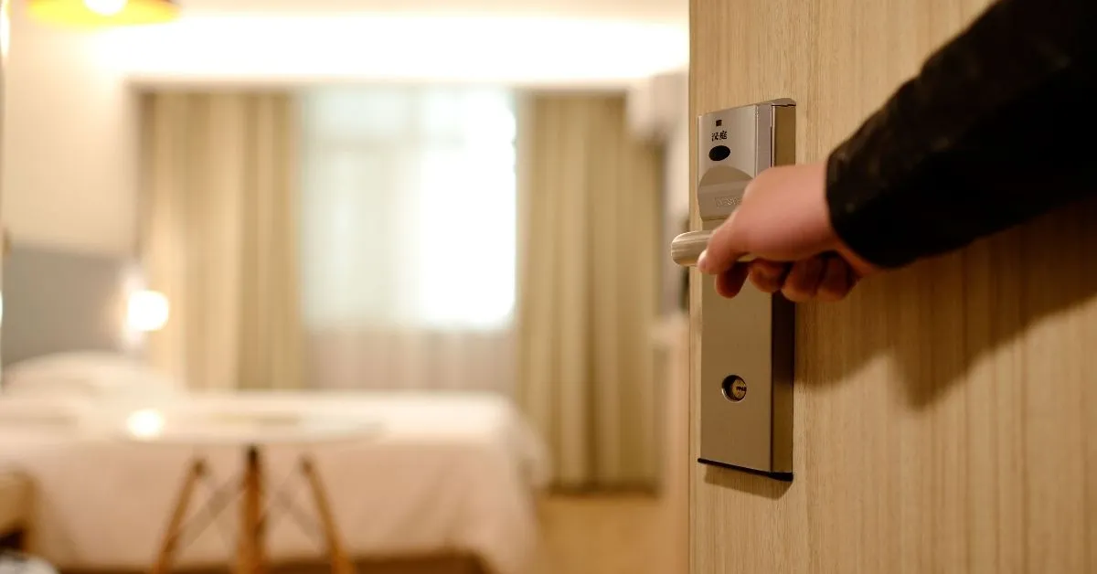 person entering a hotel room