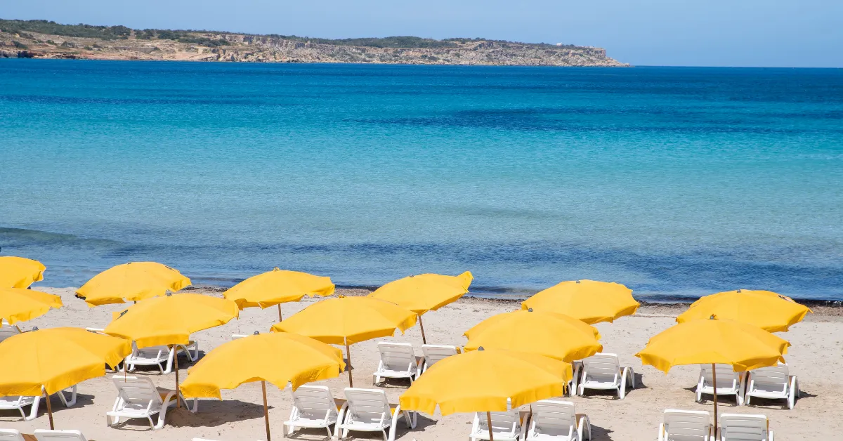 yellow beach umbrellas in malta