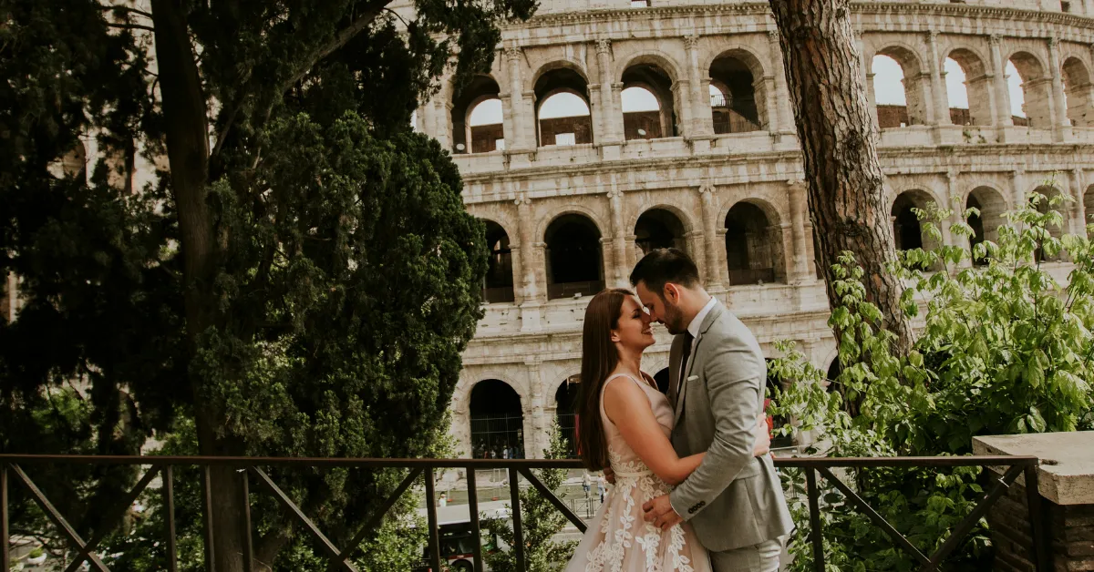 couple eloping in italy in front of the rome colosseum