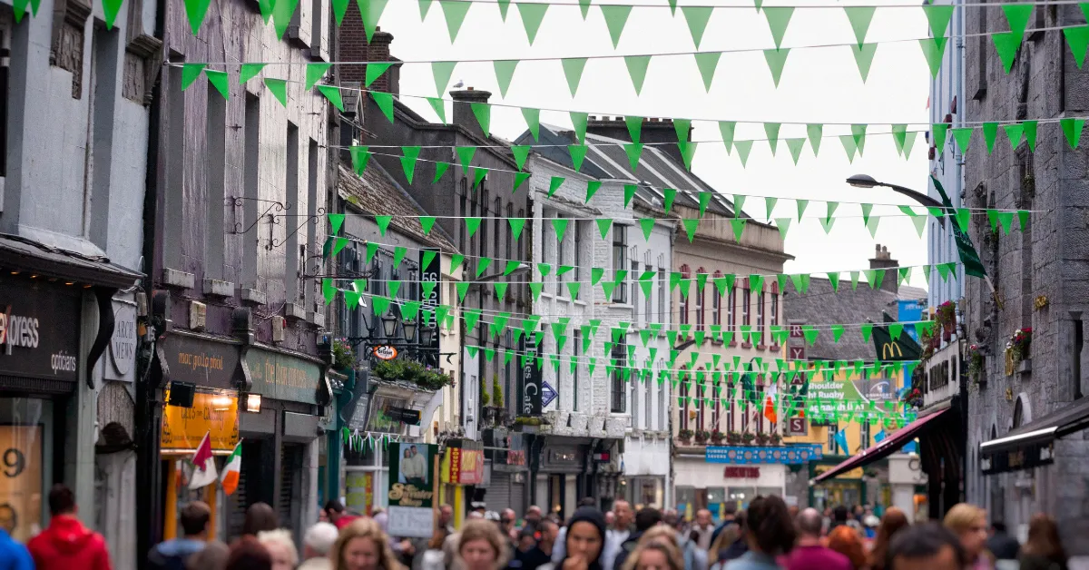festival in galway with green banners and people