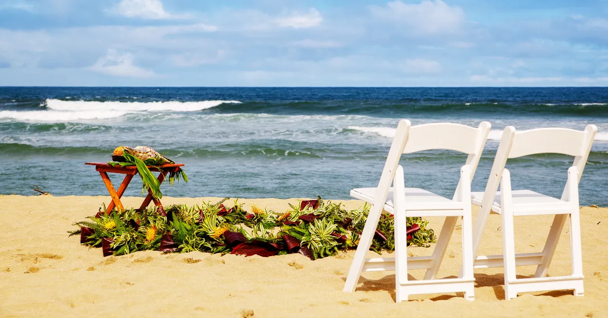 two chairs and wedding decor on a beach