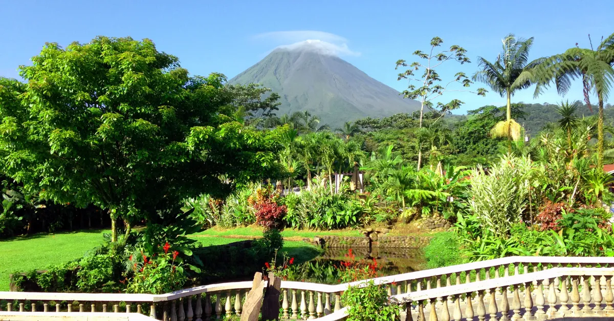 la fortuna trees and walk bridge with volcano in background