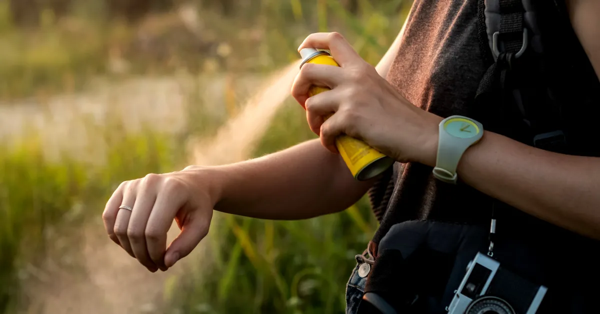 girl using spray mosquito repellent