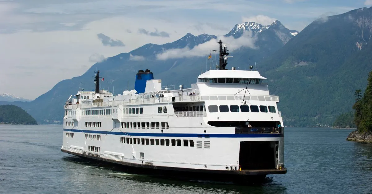 ferry on a lake close to the mountains