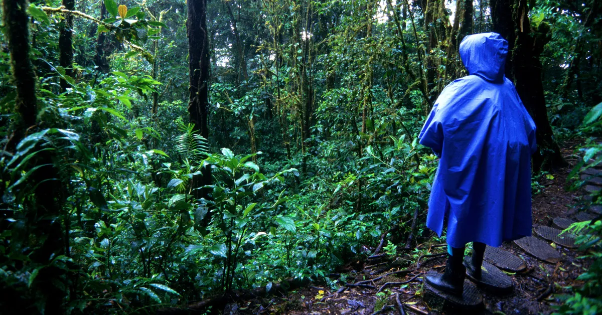person wearing a blue backpacking poncho