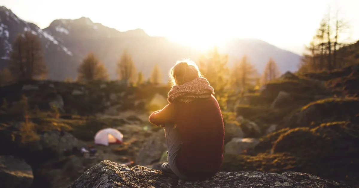 Woman camping in the mountains