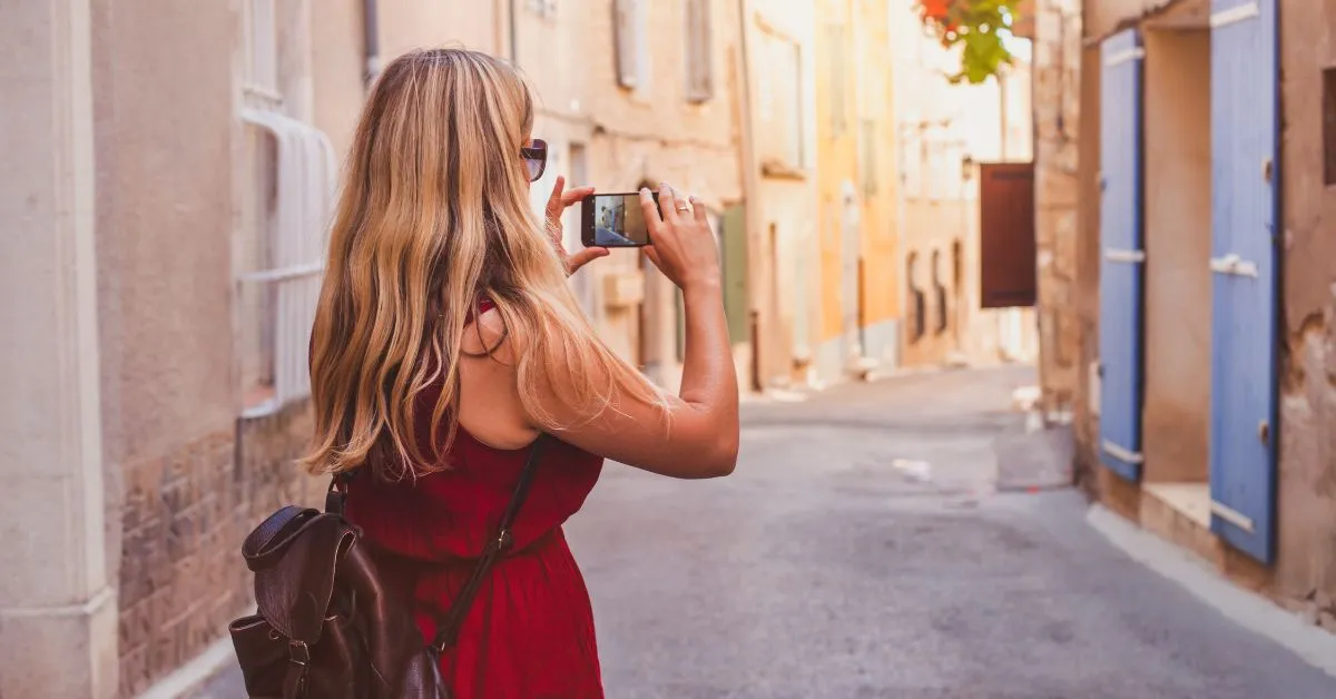 Woman in Europe taking a photo with her mobile phone