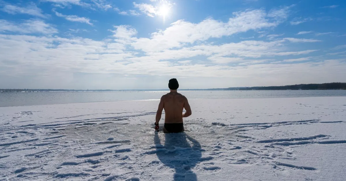 man taking ice bath in lake