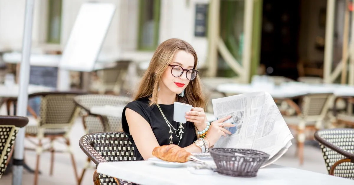 woman having coffee and croissant at paris cafe