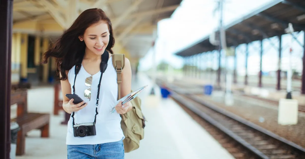 Traveler with a mobile phone in her hand