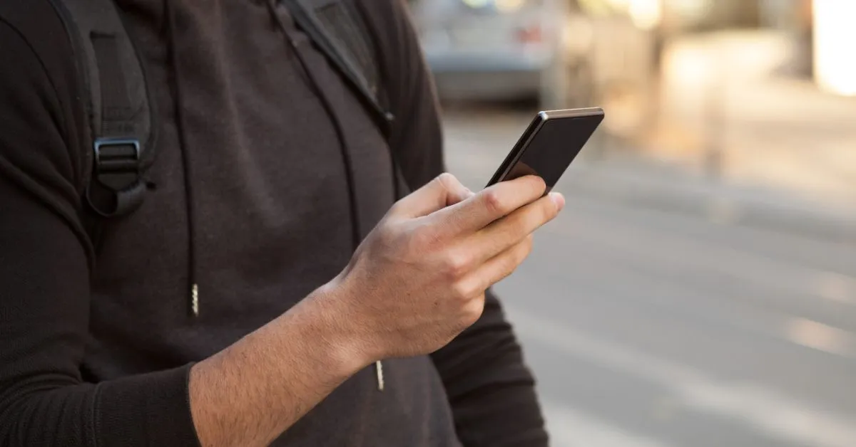 Traveler walking with his phone