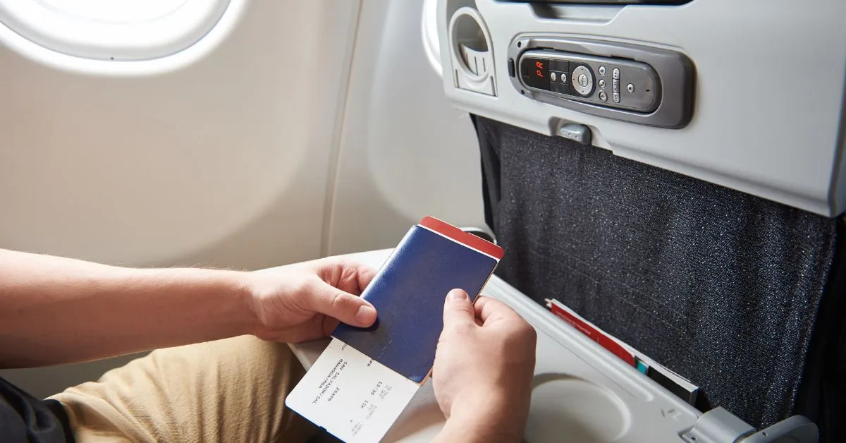 Man with passport and boarding pass in hands